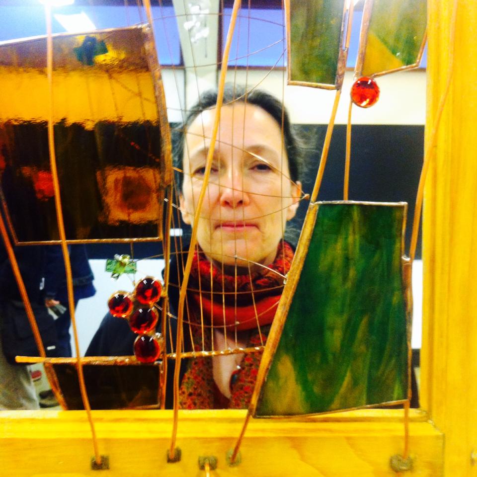 Johanne Turcotte looks through glass art